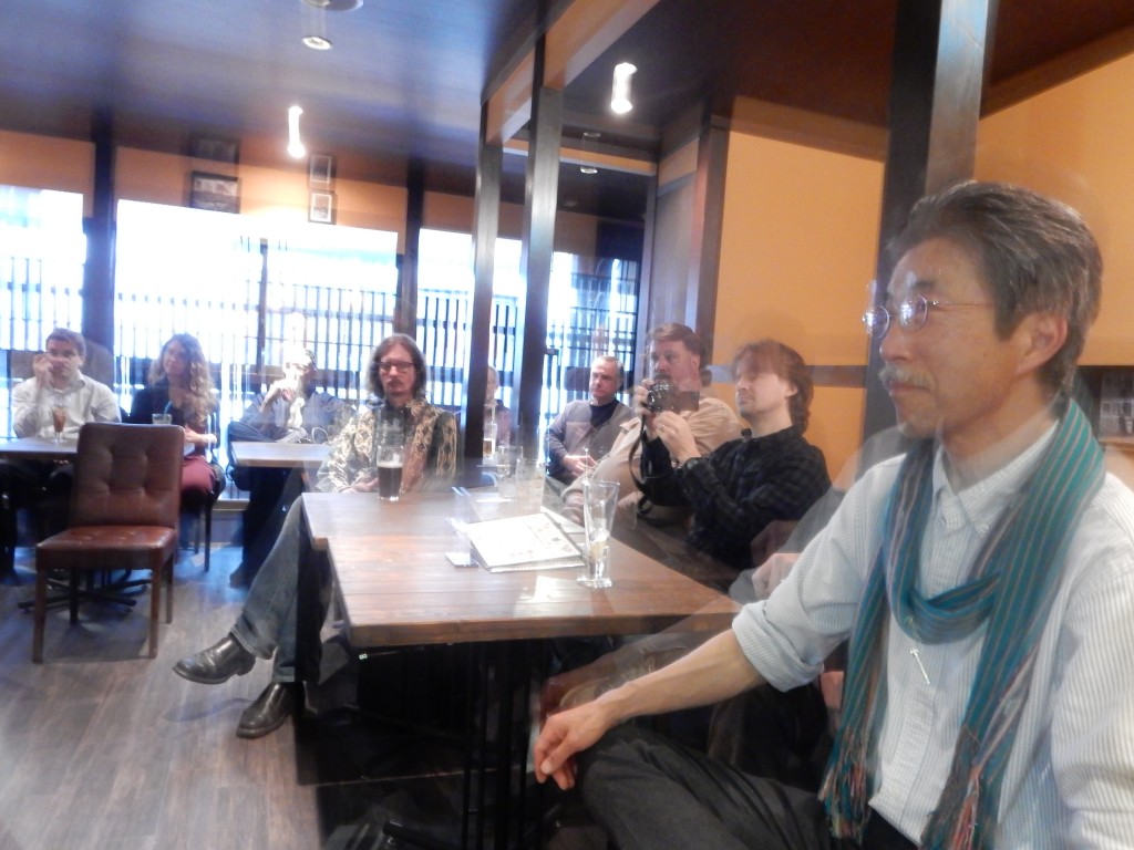 Members of the audience at Amy Chavez's speech. Terry Futaba, the earth pilgrim, in the foreground, with Michael Lambe of Deep Kyoto behind him taking pictures.